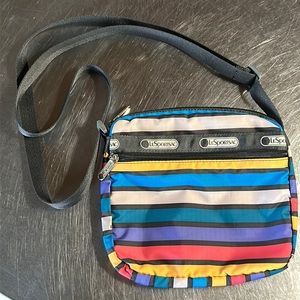 LeSportSac multi colored stripe nylon crossover bag. 8x8x2. Strap adjusts 26”L